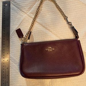 Coach Wine leather wristlet with yellow gold color accents